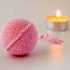 Handmade pink bath bombs with a soft, pastel hue, perfect for a relaxing spa night.