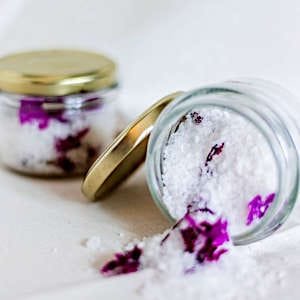A jar of homemade bath salts, infused with soothing scents and natural ingredients for a relaxing experience.