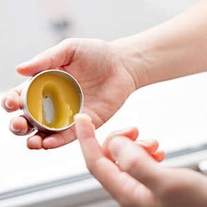 A small container filled with homemade lip balm, offering a natural and soothing skincare option.