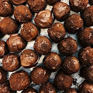 Luxurious homemade pralines with dark chocolate shells and creamy centers.