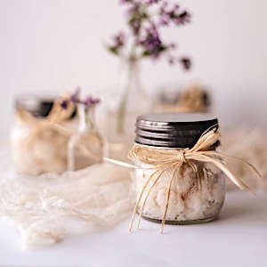 A handcrafted body scrub in a cute jar, made with natural ingredients.